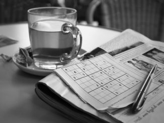 Newspaper with sudoku puzzle half completed