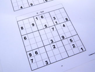 Hard sudoku puzzle book opened and ready to start