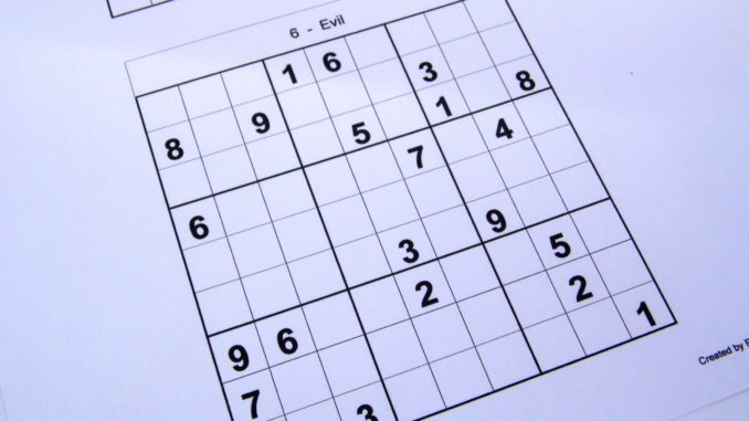 Hard sudoku puzzle book opened and ready to start