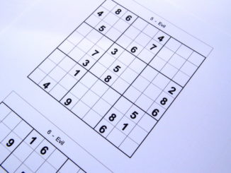 Sudoku puzzle book opened and ready to start