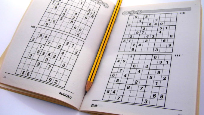 Sudoku puzzle book opened and ready to start