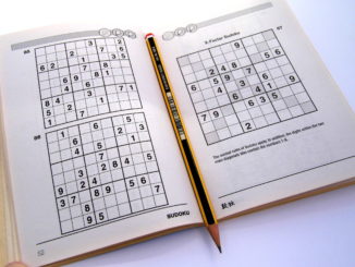 Sudoku puzzle book opened and ready to begin