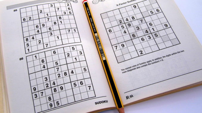 Sudoku puzzle book opened and ready to begin