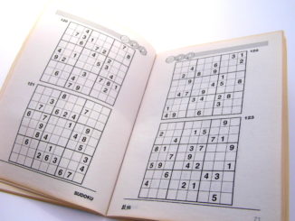 Sudoku puzzle book opened and ready to begin