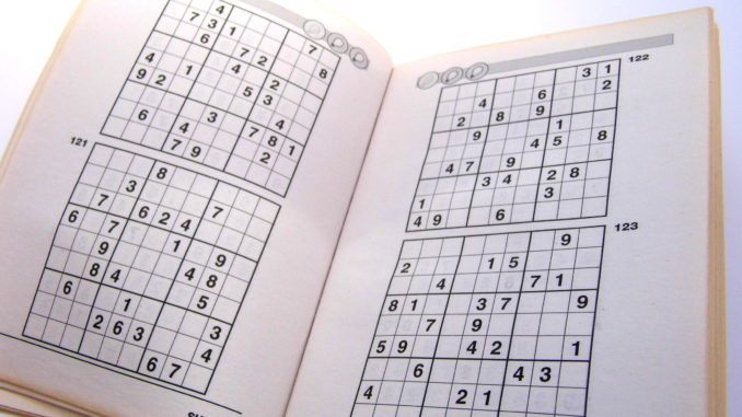 Sudoku puzzle book opened and ready to begin